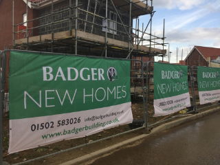 Heras Fence Covers with green printed artwork used to cover heras fence panels at a Construction Site
