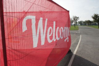 A red heras mesh banner on a heras fence panel at a construction site